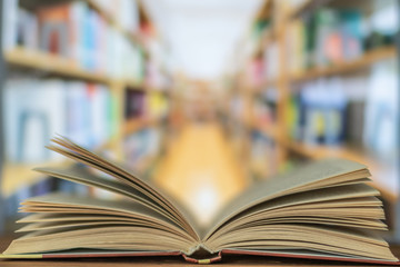 Open book on the desk in the library room