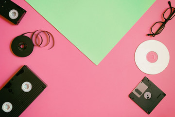 Retro storage devices: plate, two videocassette, floppy disk, CD and glasses. Outdated technology...