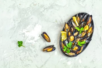 Fotobehang Seafood mussels with lemon and parsley in black metal plate © Victoria Kondysenko