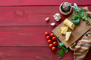 Ingredients for Italian cuisine. Red wooden background.