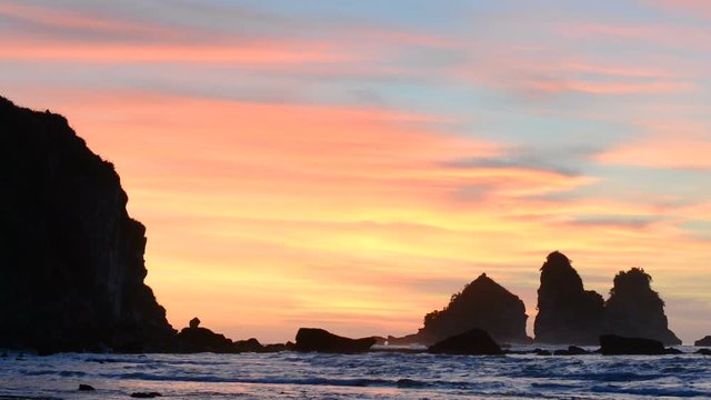 Colourful stunning sunset over the Tasman Sea coast, New Zealand