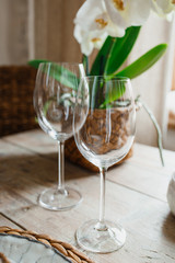 Two glasses of champagne standing on a wooden table