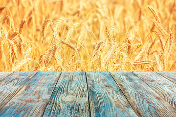 Rural background, template - horizontal surface of the boards on the background of wheat field, with space for text
