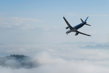Fototapeta na wymiar Airplane over the clouds,