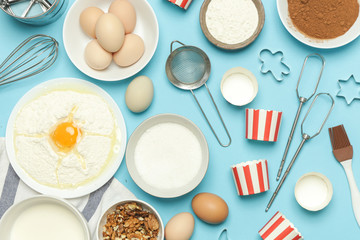 Creating a recipe, Top view of the basic baking ingredients and kitchen utensils on the blue table, cooking concept
