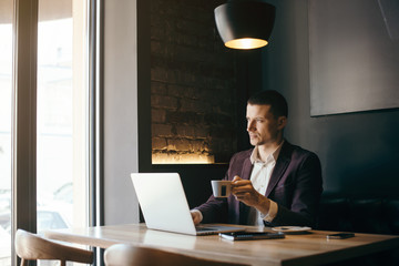 Young handsome businessman conducting negotiations with investors. Electronic business. Alternative...