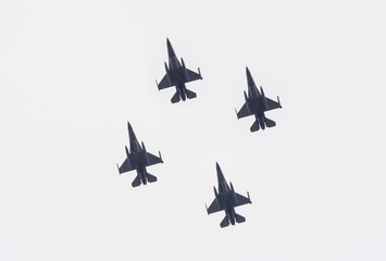 Formation of modern fighter jets in flight equipped with bombs and missiles ready to attack. Shot...