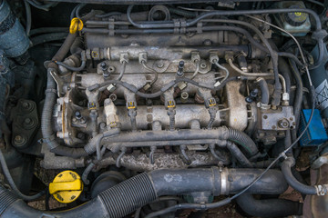 Old used diesel engine with rusty and dirty auto parts, water infiltration and bad car maintenance.  