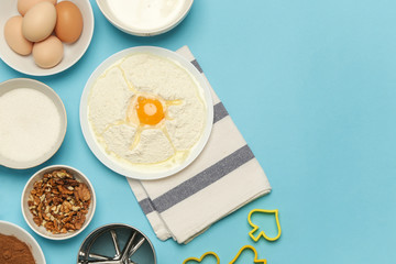 Creating a recipe, Top view of the basic baking ingredients on the blue table, cooking concept