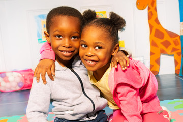 boy hug girl African appearance in kindergarten