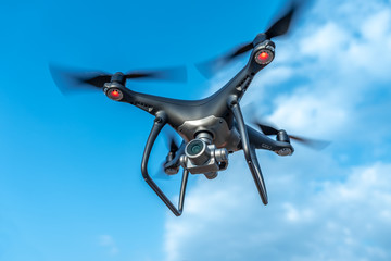 Modern beautiful dark drone in the sky.