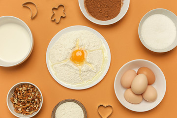 Creating a recipe, Top view of the basic baking ingredients on the orange table, cooking conceptCreating a recipe, Top view of the basic baking ingredients on the orange table, cooking concept