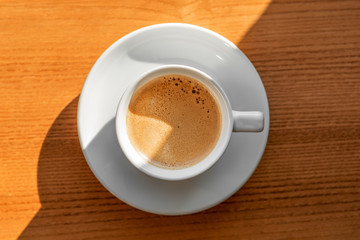 Cup of coffee with brown sugar on a wooden table