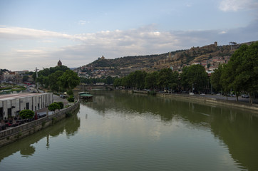 Fototapeta na wymiar View from the Bridge of Peace in Tbilisi, a pedestrian bridge over the Mtkvari River in Tbilisi, Georgia