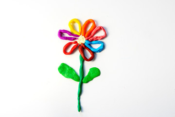 bright blue red yellow green flower pattern made by baby. development of the child's speech through motor skills. exercises at home and at school for children's hands with plasticine.
