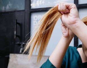 Texture of damaged female hair close-up. concept weak hair from hair dying.