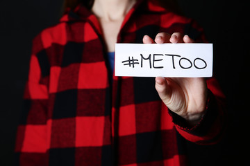 Woman holding paper with text Me Too