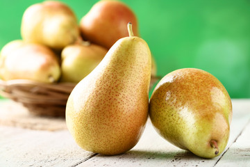Ripe pears on white wooden table