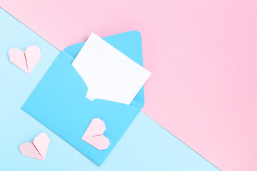 Blue paper envelope and hearts on colorful background