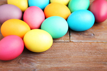 Fototapeta na wymiar Colorful easter eggs on brown wooden table