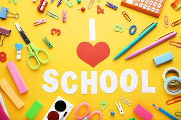 Inscription I Love School with school supplies on yellow background
