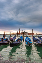 Fototapeta na wymiar Gondolas moored in Piazza San Marco with San Giorgio Maggiore church in the background, Italy
