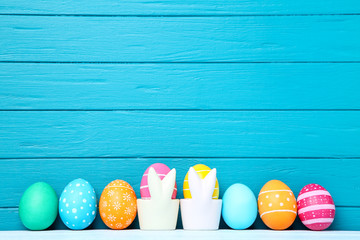Colorful easter eggs on blue wooden background