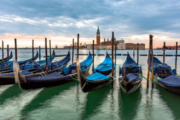 Fototapeta na wymiar Gondolas moored in Piazza San Marco with San Giorgio Maggiore church in the background, Italy