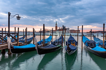 Fototapeta premium Gondolas moored in Piazza San Marco with San Giorgio Maggiore church in the background, Venice, Italy