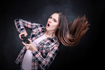 Beautiful girl with joystick on black background