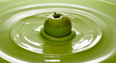 Close up of green apple in paint