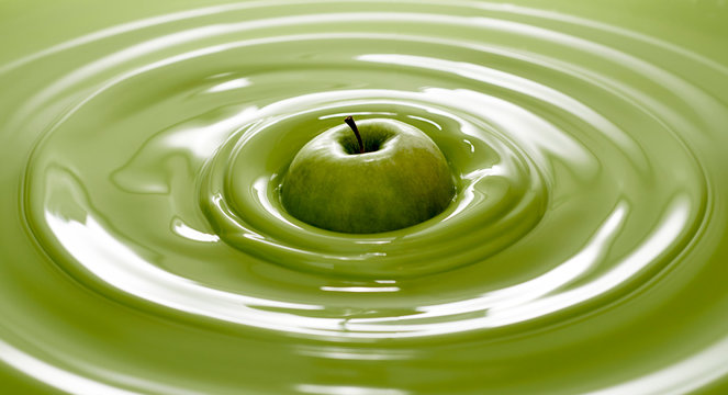 Close up of green apple in paint