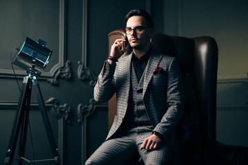 Young handsome man posing for a fashion shoot in a studio. Fashion as a lifestyle. Man wearing a...