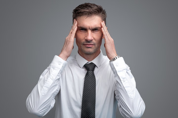 Tired businessman rubbing temples