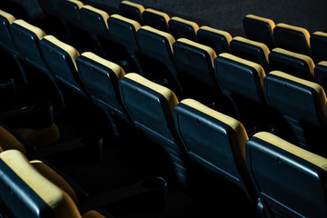 rows of comfortable plastic empty seats in cinema hall