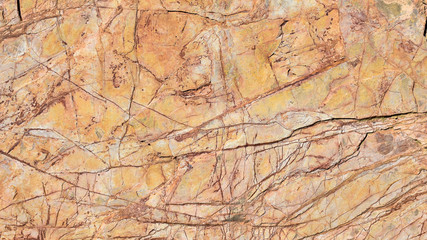 close up of a scratched old orange stone of an architectural wall decorating the interior of a house. Horizontal photo