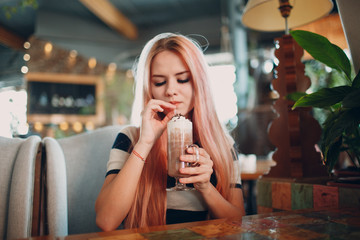 Young girl drinks hot chocolate cocoa drink.