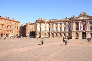 Fototapeta na wymiar Toulouse central square and the emblematic and majestic Capitole, a town hall and theatre in the heart of the pink city, the major city of Southwestern France and historical capital of Languedoc