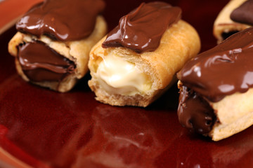 Traditional French dessert. Eclair with chocolate icing. Pastery concept with chocolate eclair