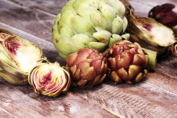 Obraz premium artichokes on grey background. fresh organic artichoke flower vegetable