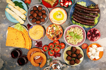 Middle eastern or arabic dishes and assorted meze, concrete rustic background. Falafel. Turkish Dessert Baklava with pistachio. Halal food. Lebanese cuisine