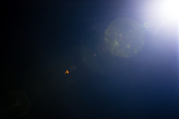 Flash of a distant abstract star. Abstract sun flare. The lens flare is subject to digital...