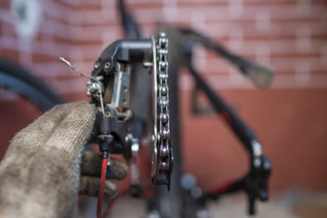 Fototapeta na wymiar Bicycle mechanic in a workshop in the repair process 