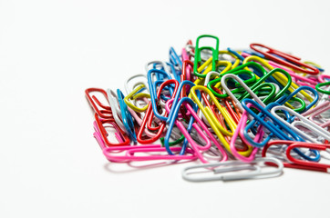 Colorful paper clips to documents lying on a white background