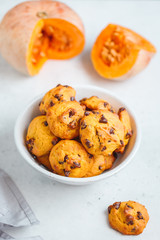 Pumpkin cookies with chocolate chips made from cake mix in a white ceramic bowl.