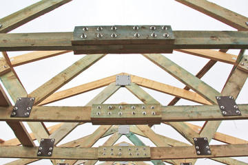 Roof structure in the new house. Bolting of wooden beams.