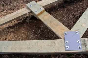 Roof structure in the new house. Bolting of wooden beams.