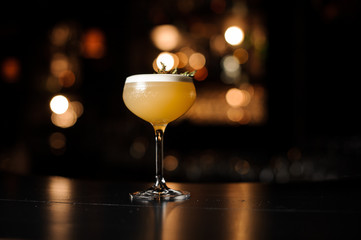 Light brown cocktail on a bar counter