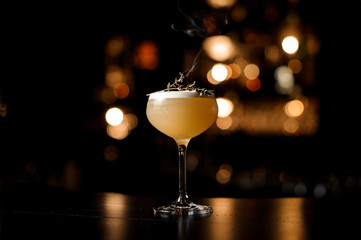 Light brown cocktail on a bar counter