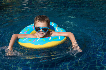 One little happy boy  playing on the inflatable circle